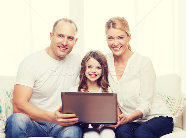 parents and little girl with laptop at home Stock photo © dolgachov