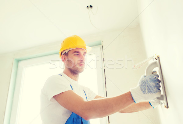 builder with grinding tool indoors Stock photo © dolgachov