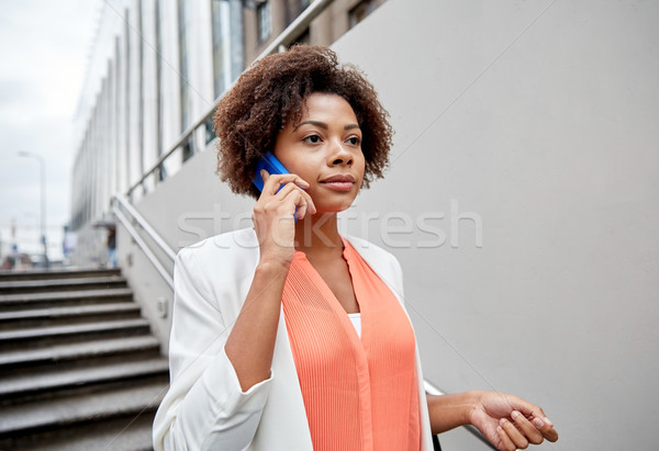african businesswoman calling on smartphone Stock photo © dolgachov