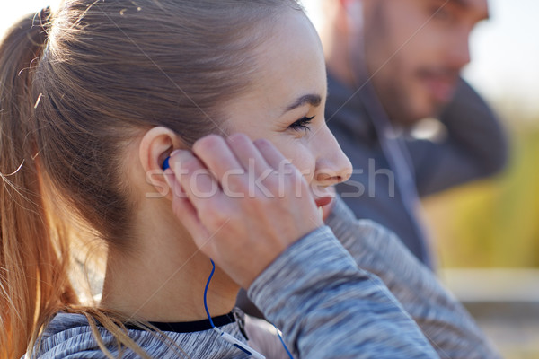 happy woman with earphones listening to music Stock photo © dolgachov