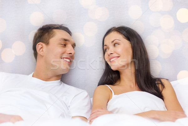 happy couple dreaming in bed Stock photo © dolgachov