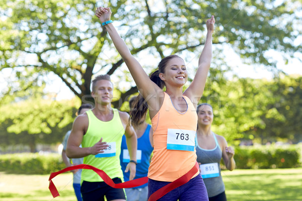 Stock photo: happy young female runner winning on race finish