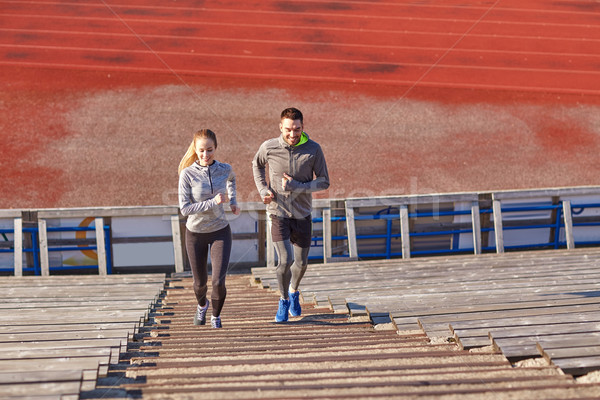 Boldog pár fut emeleten stadion fitnessz Stock fotó © dolgachov