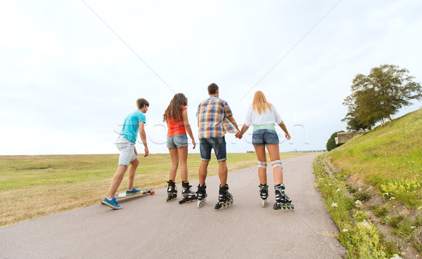 teenagers with rollerblades and longboards Stock photo © dolgachov