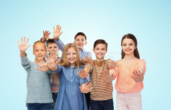 happy children waving hands Stock photo © dolgachov