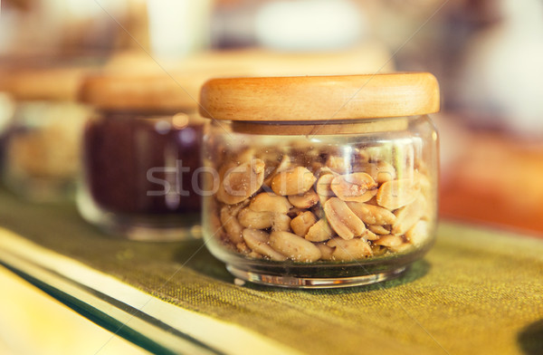 close up of jars with peanuts at grocery store Stock photo © dolgachov
