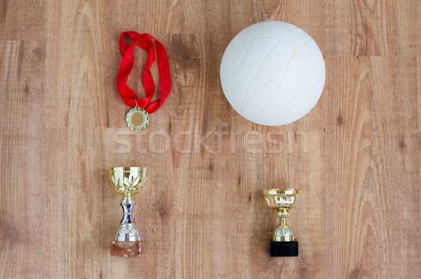 Stock photo: close up of volleyball ball, cups and medals