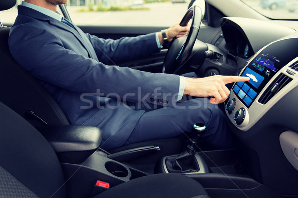 close up of man driving car with board computer Stock photo © dolgachov