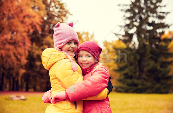 two happy little girls hugging in autumn park Stock photo © dolgachov