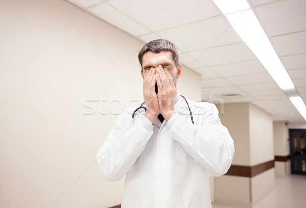 sad or crying male doctor at hospital corridor Stock photo © dolgachov