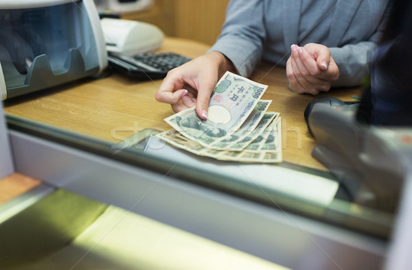 clerk counting cash money at bank office Stock photo © dolgachov