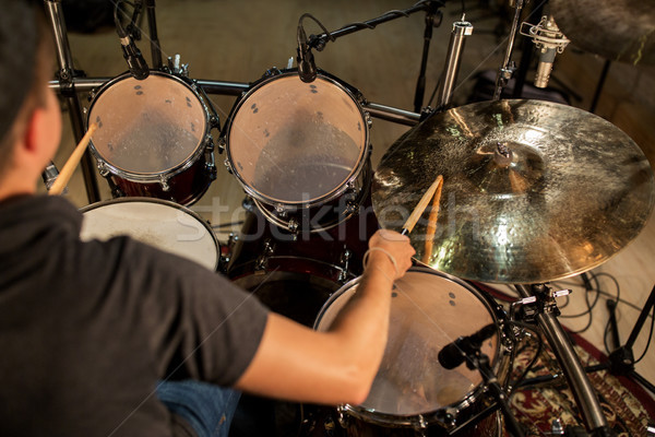 male musician playing drums and cymbals at concert Stock photo © dolgachov
