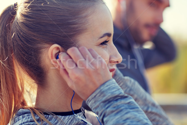 happy woman with earphones listening to music Stock photo © dolgachov