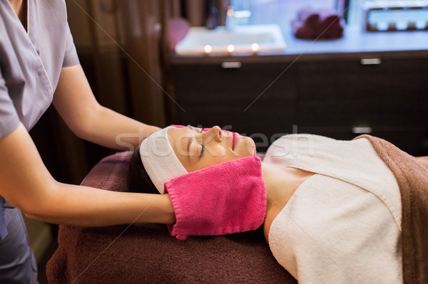 woman having face massage with terry gloves at spa Stock photo © dolgachov
