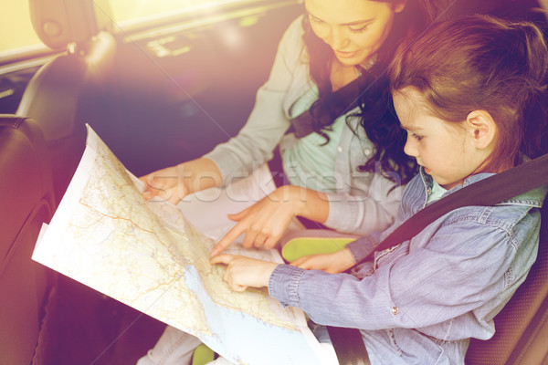 happy family with travel map driving in car Stock photo © dolgachov