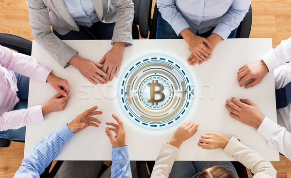 business team at table with bitcoin icon Stock photo © dolgachov