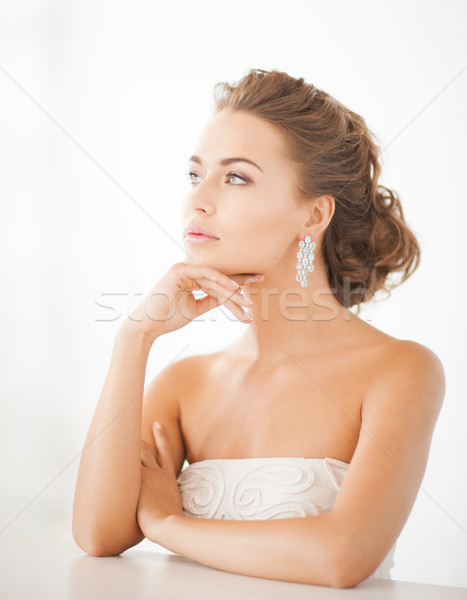 Femme brillant diamant boucles d'oreilles [[stock_photo]] © dolgachov
