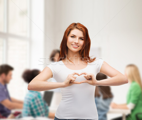 smiling girl showing heart with hands Stock photo © dolgachov