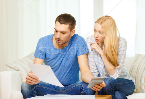 busy couple with papers and calculator at home Stock photo © dolgachov