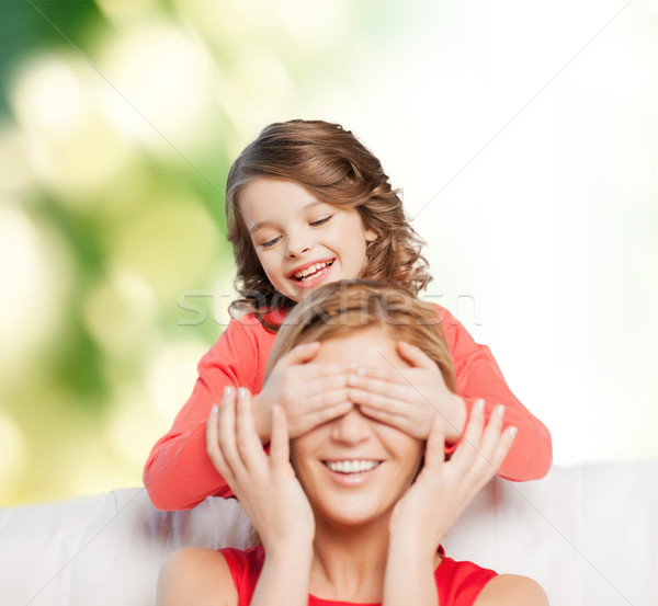 Stock photo: smiling mother and daughter making a joke