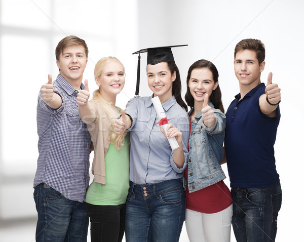 group of students with diploma showing thumbs up Stock photo © dolgachov