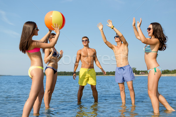 smiling friends in sunglasses on summer beach Stock photo © dolgachov