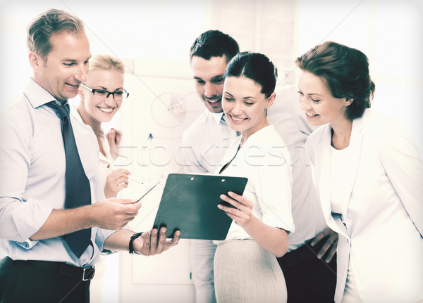 üzleti csapat megbeszél valami iroda mosolyog üzlet Stock fotó © dolgachov