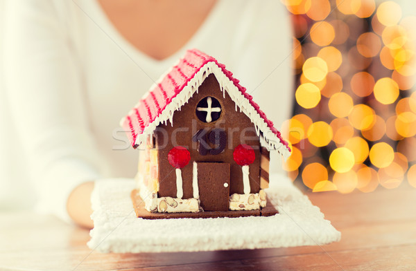 close up of woman showing gingerbread house Stock photo © dolgachov
