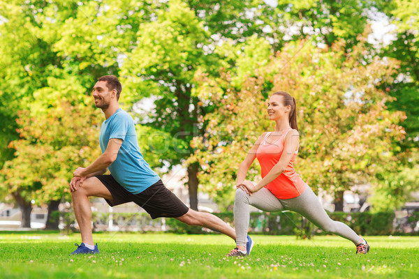 smiling couple stretching outdoors Stock photo © dolgachov