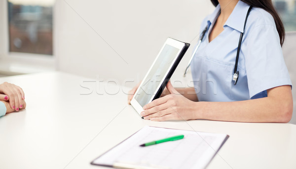 Stock photo: close up of doctor showing x-ray on tablet pc