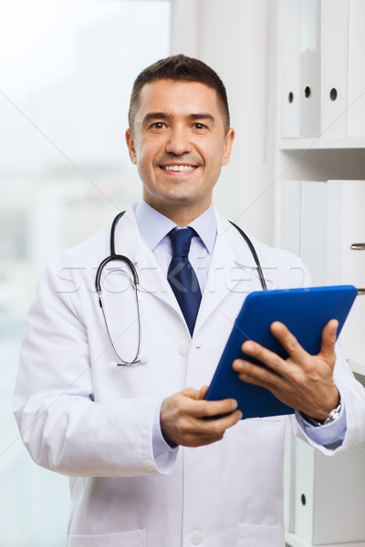 Stock photo: smiling male doctor in white coat with tablet pc