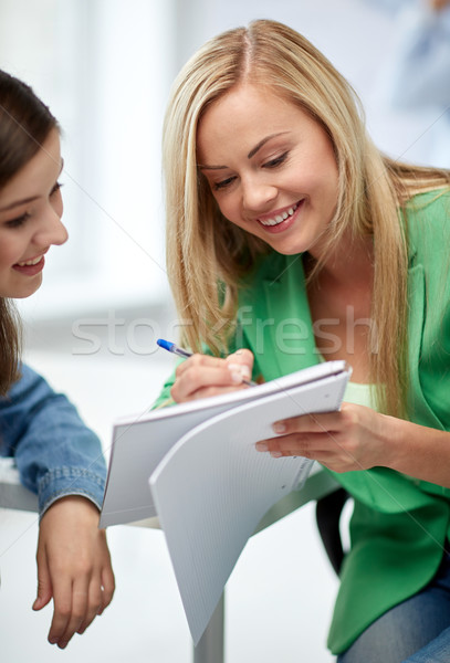 happy high school student girls with note book Stock photo © dolgachov