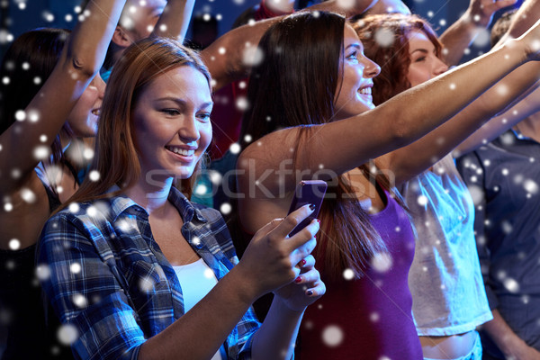 woman with smartphone texting message at concert Stock photo © dolgachov