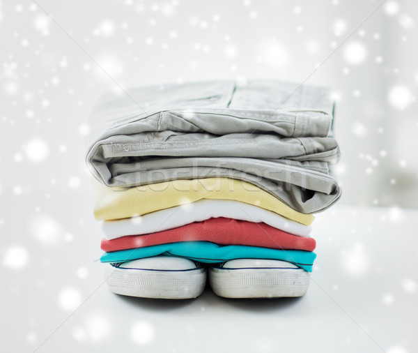 close up of folded shirts and boots on table Stock photo © dolgachov