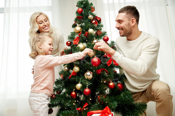 Happy Family Decorating Christmas Tree At Home Stock Photo Dolgachov 6526085 Stockfresh - A Family By Decorating Christmas Tree At Home