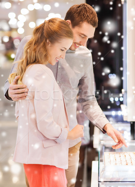 happy couple choosing engagement ring in mall Stock photo © dolgachov