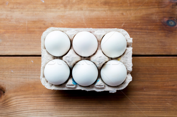 close up of white eggs in egg box or carton Stock photo © dolgachov