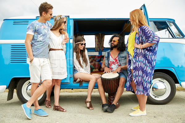 hippie friends with tom-tom playing music over car Stock photo © dolgachov