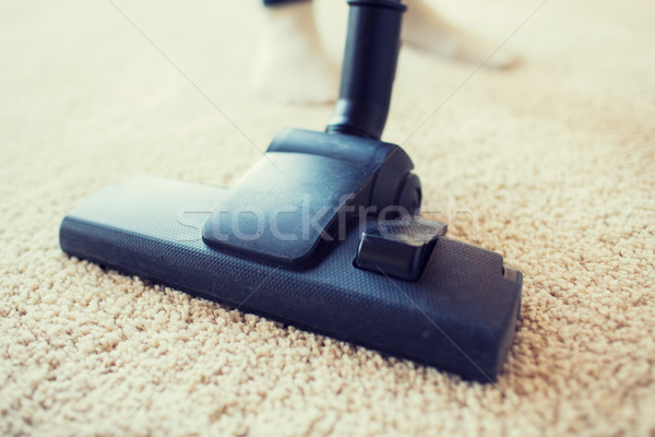 close up of vacuum cleaner cleaning carpet at home Stock photo © dolgachov
