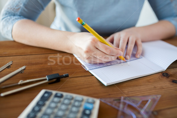 Stock photo: close up of hands with ruler and pencil drawing 