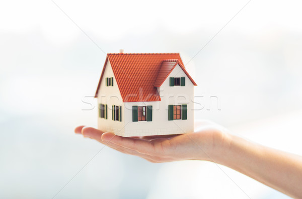 close up of hands holding house or home model Stock photo © dolgachov