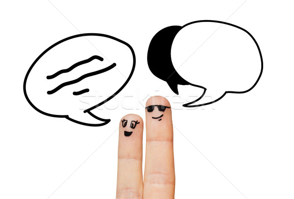 close up of two fingers with communication clouds Stock photo © dolgachov