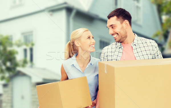 couple with cardboard boxes moving to new home Stock photo © dolgachov