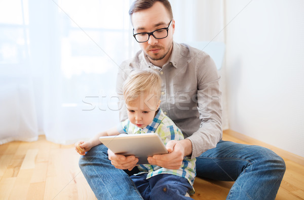 Stock photo: father and son with tablet pc playing at home