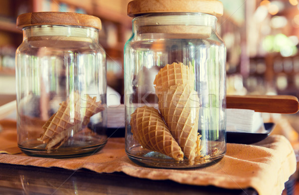 close up of jars with waffle cones at restaurant Stock photo © dolgachov
