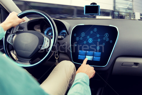 close up of man driving car with on board computer Stock photo © dolgachov