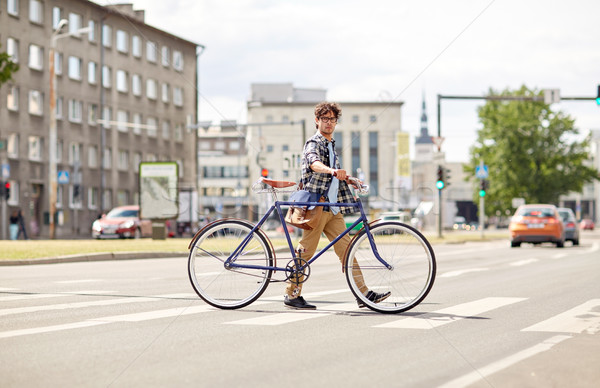 young man with fixed gear bicycle on crosswalk Stock photo © dolgachov