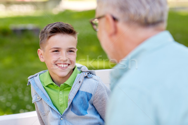 grandfather and grandson talking at summer park Stock photo © dolgachov