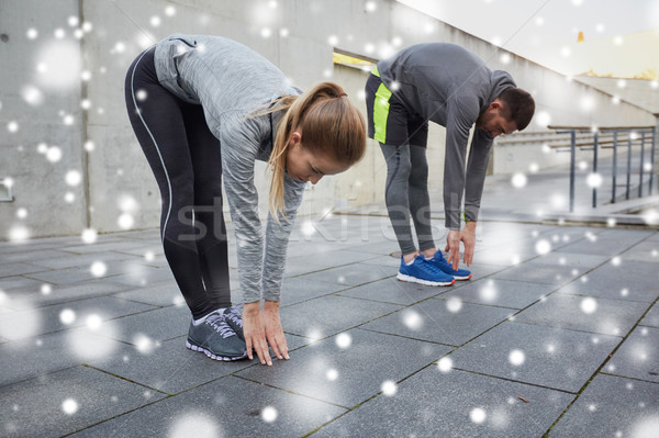 Pár nyújtás görbület előre fitnessz sport Stock fotó © dolgachov