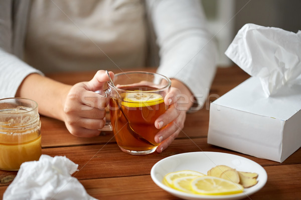 close up of ill woman drinking tea with lemon Stock photo © dolgachov